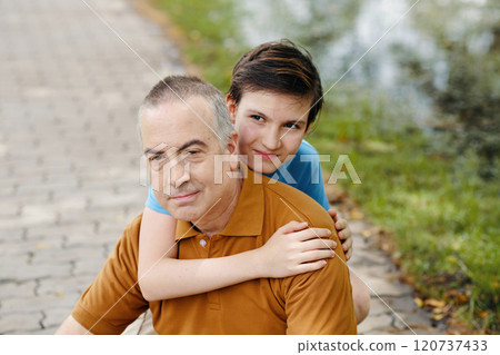 Grandson Embracing His Senior Grandfather 120737433