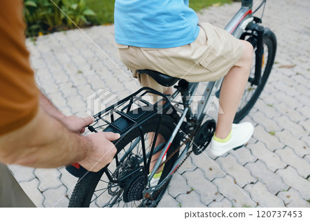 Grandfather Teaching Boy To Ride A Bike Grandfather Teaching Boy To Ride A Bike 120737453