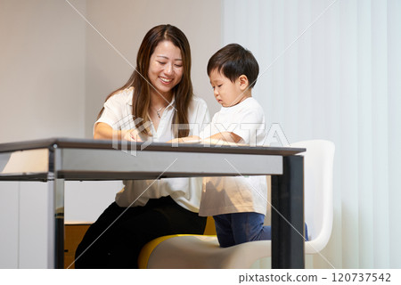 Parent and child playing with origami Parent and child playing with origami 120737542