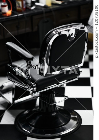 Classic barber chair in a retro style barbershop with black and white flooring Classic barber chair in a retro style barbershop with black and white flooring 120738100