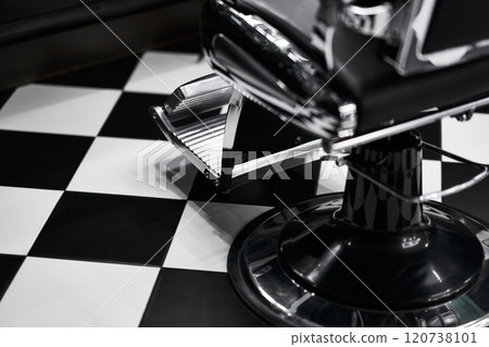 Classic barber chair on a black and white checkered floor Classic barber chair on a black and white checkered floor 120738101