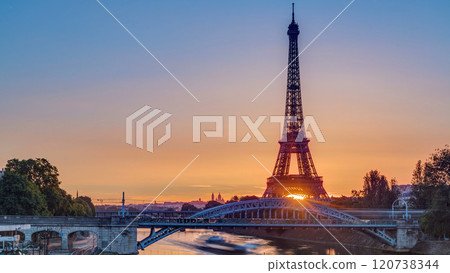 Eiffel Tower sunrise timelapse with boats on Seine river and in Paris, France. Eiffel Tower sunrise timelapse with boats on Seine river and in Paris, France. 120738344
