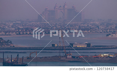 A breathtaking aerial view of the Palm Jumeirah night to day timelapse from a rooftop, Dubai, United Arab Emirates A breathtaking aerial view of the Palm Jumeirah night to day timelapse from a rooftop, Dubai, United Arab Emirates 120738417