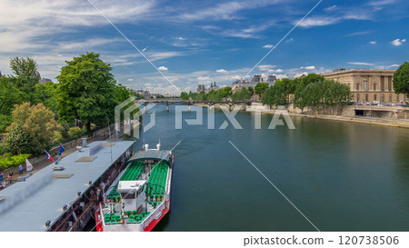Touristic boat passes below Pont des Arts and stop on boat station on Seine river timelapse hyperlapse in Paris. 120738506