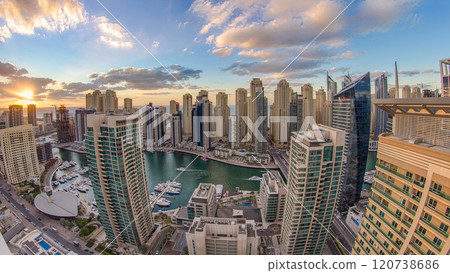 Modern skyscrapers and water channel with boats of Dubai Marina at sunset and day to night timelapse, United Arab Emirates. Modern skyscrapers and water channel with boats of Dubai Marina at sunset and day to night timelapse, United Arab Emirates. 120738686