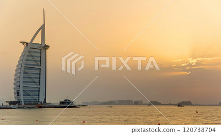 Dubai skyline with Burj Al Arab hotel during sunset timelapse. Dubai skyline with Burj Al Arab hotel during sunset timelapse. 120738704