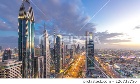 Dubai downtown architecture day to night timelapse. Top view over Sheikh Zayed road with illuminated skyscrapers and traffic. Dubai downtown architecture day to night timelapse. Top view over Sheikh Zayed road with illuminated skyscrapers and traffic. 120738750