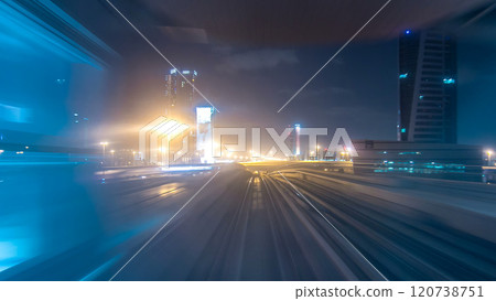 Front cabin POV view from modern driver-less metro train rush forward, along night Dubai, smooth timelapse. 120738751