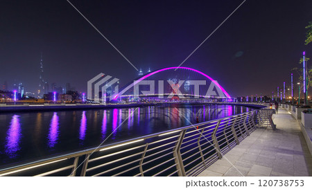 Pedestrian Bridge over the Dubai Water Canal night timelapse hyperlapse, United Arab Emirates 120738753