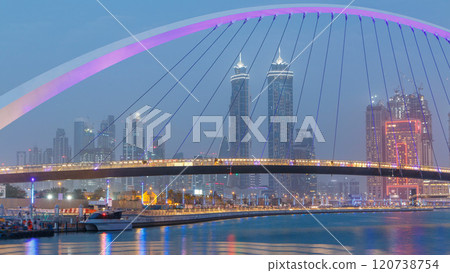 Pedestrian Bridge over the Dubai Water Canal day to night timelapse, United Arab Emirates Pedestrian Bridge over the Dubai Water Canal day to night timelapse, United Arab Emirates 120738754