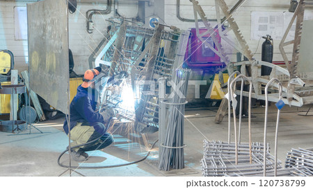 welder working with electrode at semi-automatic arc welding in manufacture production plant timelapse 120738799