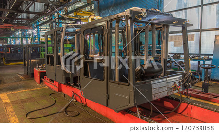 Conveyor assembly stage the body of tractor at big industrial factory timelapse Conveyor assembly stage the body of tractor at big industrial factory timelapse 120739038