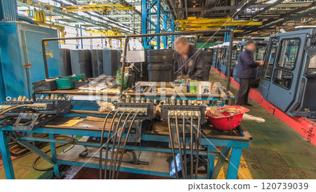 Conveyor assembly stage the body of tractor at big industrial factory timelapse 120739039