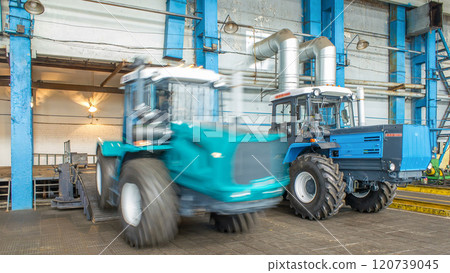 Conveyor assembly final stage of tractor at factory timelapse Conveyor assembly final stage of tractor at factory timelapse 120739045