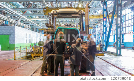 Conveyor assembly stage the body of tractor at big industrial factory timelapse Conveyor assembly stage the body of tractor at big industrial factory timelapse 120739048