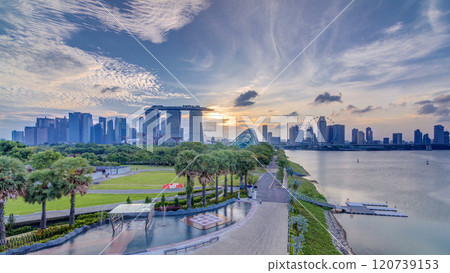 Marina Bay Sands, Gardens by the bay with cloud forest, flower dome and supertrees at sunset timelapse 120739153