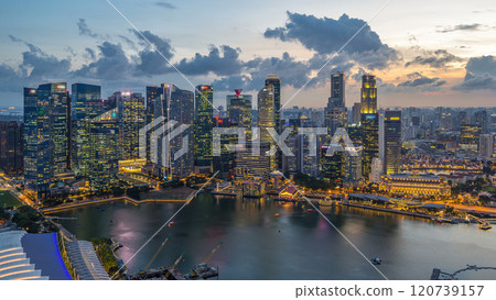 Aerial view of Singapore business district skyscrapers at evening with water reflections day to night timelapse Aerial view of Singapore business district skyscrapers at evening with water reflections day to night timelapse 120739157
