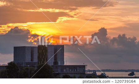 Beautiful sunrise at Marina Barrage timelapse. Orange sky and clouds with sun beams. Beautiful sunrise at Marina Barrage timelapse. Orange sky and clouds with sun beams. 120739164