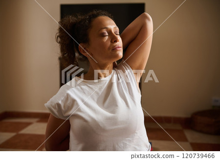 Relaxed woman experiencing mindfulness during home yoga session Relaxed woman experiencing mindfulness during home yoga session 120739466