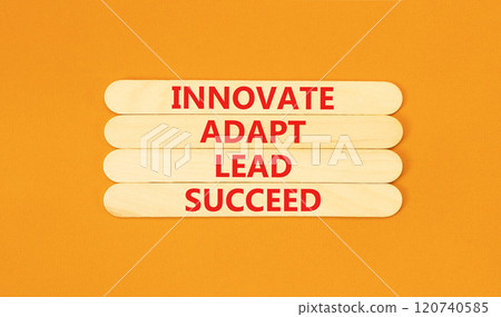 Innovate adapt lead succeed symbol. Concept words Innovate Adapt Lead Succeed on beautiful wooden sticks. Beautiful orange background. Business innovate adapt lead succeed concept. Copy space. 120740585