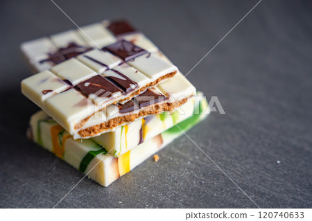 Piece of trend Dubai white chocolate with halva paste. Confectionery handmade sweets at home in the kitchen.  120740633