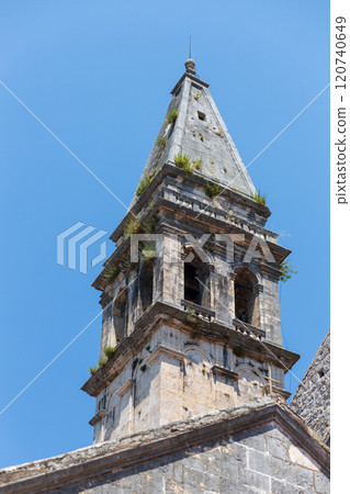 Historic bell tower of Perast, Montenegro rises against clear blue sky Historic bell tower of Perast, Montenegro rises against clear blue sky 120740649