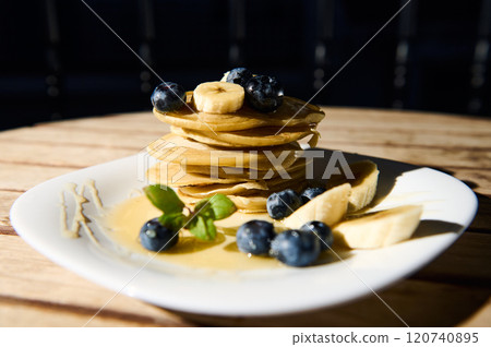 Delicious stack of pancakes with blueberries and bananas 120740895