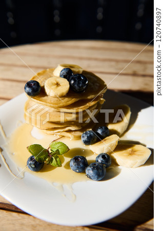 Delicious stack of pancakes with bananas and blueberries Delicious stack of pancakes with bananas and blueberries 120740897