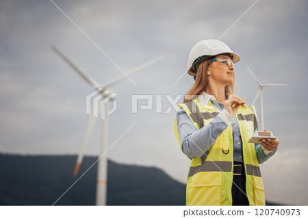 An engineer presents a detailed wind turbine model, showcasing progress in renewable energy and emphasizing his expertise in sustainable solutions crucial for a greener future for everyone 120740973