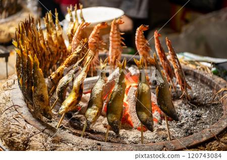 Salt-grilled sweetfish sold at a festival stall in Japan Salt-grilled sweetfish sold at a festival stall in Japan 120743084