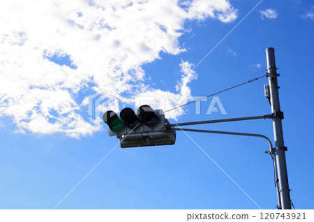 A photo of a traffic light with a blue sky in the background 120743921