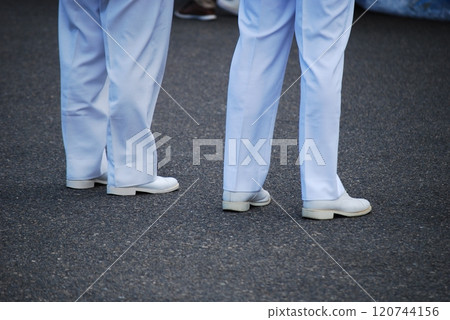 The feet of a man in uniform 120744156