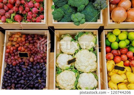 Colorful arrangements of ripe fruits, fresh vegetables are displayed in wooden crates at local farmers market. Colorful arrangements of ripe fruits, fresh vegetables are displayed in wooden crates at local farmers market. 120744206