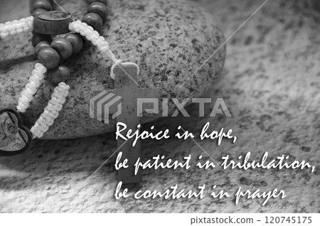 Praise and worship text text with Holy Rosary on a rock. Religious concept Praise and worship text text with Holy Rosary on a rock. Religious concept 120745175