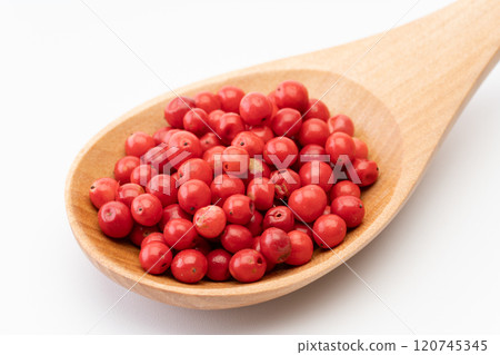 Pink pepper on a wooden spoon Pink pepper on a wooden spoon 120745345