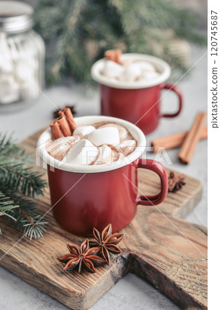 Two red enamel mugs with hot chocolate 120745687