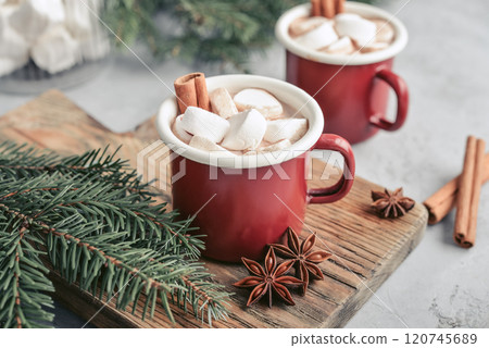 Two red enamel mugs with hot chocolate 120745689