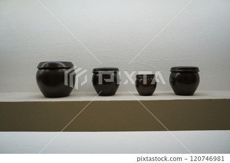 Miniature Korean jars on a shelf Miniature Korean jars on a shelf 120746981