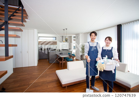 A young Japanese couple holding cleaning tools A young Japanese couple holding cleaning tools 120747639