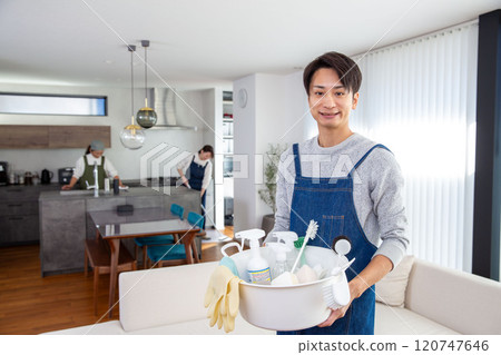 Spring cleaning: Japanese man holding cleaning tools 120747646