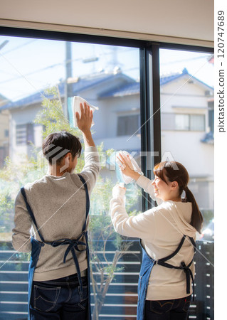Back view of a Japanese couple cleaning windows 120747689