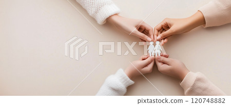 Symbolic family care with hands holding paper family members 120748882