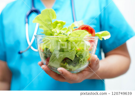 Asian Nutritionist holding healthy food for patient in hospital, nutrition and vitamin. Asian Nutritionist holding healthy food for patient in hospital, nutrition and vitamin. 120749639