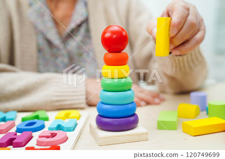 Asian elderly woman playing game. Asian elderly woman playing game. 120749699