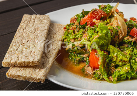 vegetable salad with tuna dressed with natural honey with rye bread closeup view 120750006