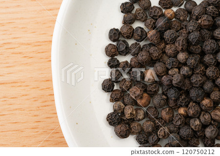 Close up of whole black peppercorns 120750212