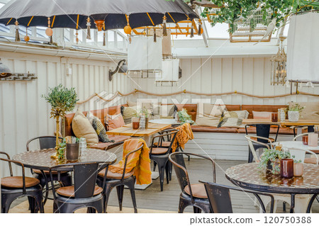 A bright and stylish cafe space with botanical decorations A bright and stylish cafe space with botanical decorations 120750388