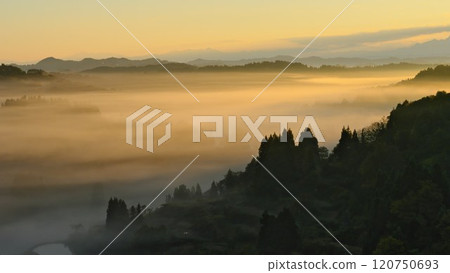 Tokamachi in autumn. The morning sun shines on Hoshi Pass, shrouded in morning mist. Tokamachi in autumn. The morning sun shines on Hoshi Pass, shrouded in morning mist. 120750693