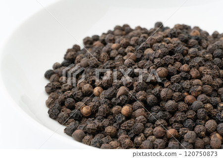 Close up of whole black peppercorns 120750873