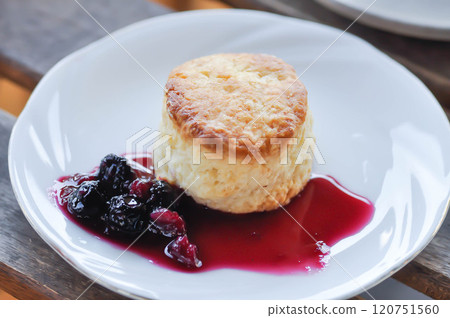 scone with berry sauce or berry dressing scone with berry sauce or berry dressing 120751560